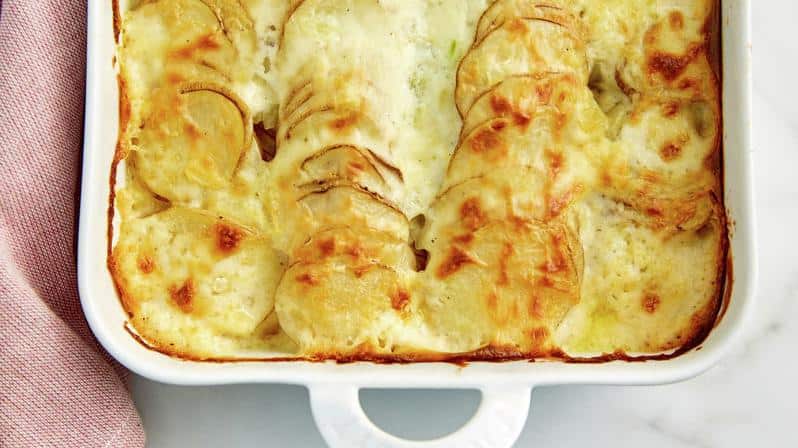  Layers upon layers of delicate potato slices, nestled in a creamy blanket of cheesy béchamel.
