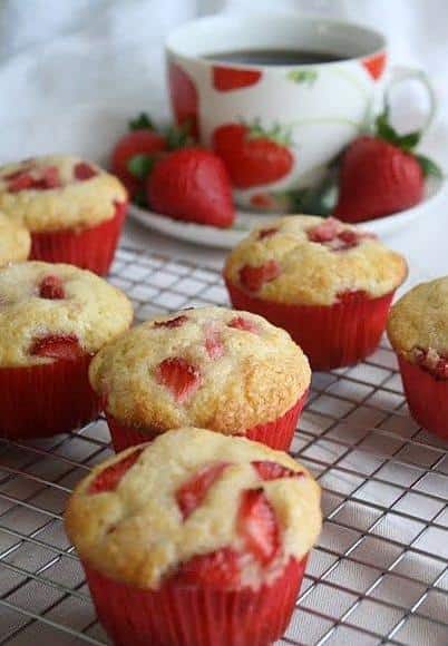  Perfectly baked golden muffins, filled with juicy strawberries and topped with whipped cream.
